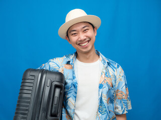 Traveler man cheerful hold luggage blue background