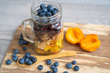 blur background, healthy organic breakfast, transparent glass cup presentation, with mix of cut...