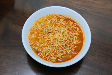 Top view of spicy noodle soup served in a bowl