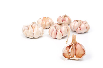 Several large heads of garlic, shot against a white background.