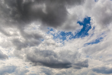 Fragment of the sky with cumulus and storm clouds