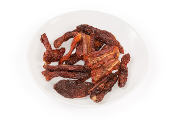 Sun-dried tomatoes on dish on a white background