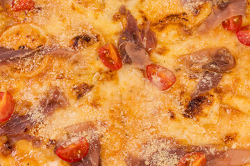 Pizza with ham and cherry tomatoes, fragment, background