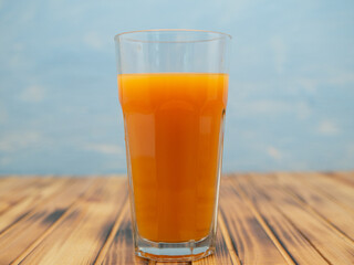 Full glass of orange juice close-up. Fresh orange juice on wooden table