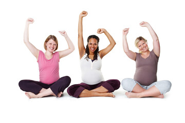 Obraz na płótnie Canvas Pregnant, happy, and healthy, women sitting on the floor, arms raised in celebration of new life. Mothers, friends, and happiness during pregnancy, a group of future moms workout on white background