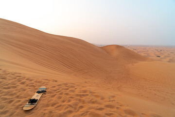 Fototapeta na wymiar Sand board activity in the Al Badayer desert with large sand dunes near Dubai