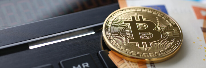Fototapeta na wymiar Bitcoin coin and cash calculator on table