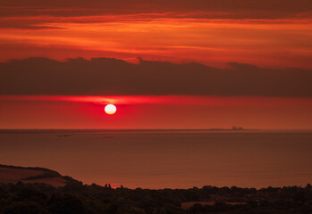 Dramatic sunrise over the south coast from the Fire Hills within Hastings Country Park East Sussex south east England UK