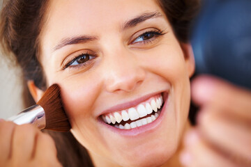 Face, beauty and makeup cosmetic brush on a woman with a happy and positive smile. Clear skin,...