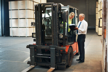Manager planning forklift logistics with factory employee for supply chain, industrial shipping and...