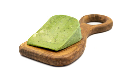 Green gouda cheese. Gouda cheese with basil isolated on a white background. Dutch cheese. close up