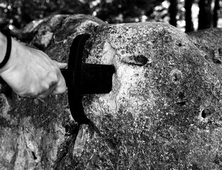 hand and sword in the stone as in the legend of King Arthur