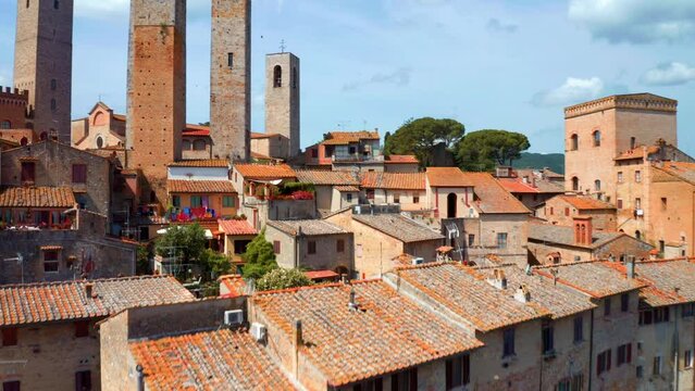 Houses With Terra Cotta Roofs Surrounding Medieval Stone Towers In Historic Centre Of San Gimignano, Italy. drone shot