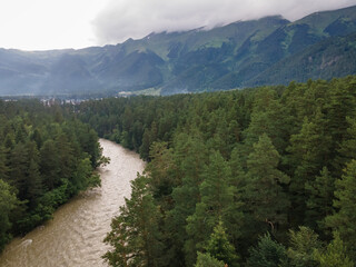 Fototapeta premium Aerial view of scenic mountain rapid river surrounded by forest