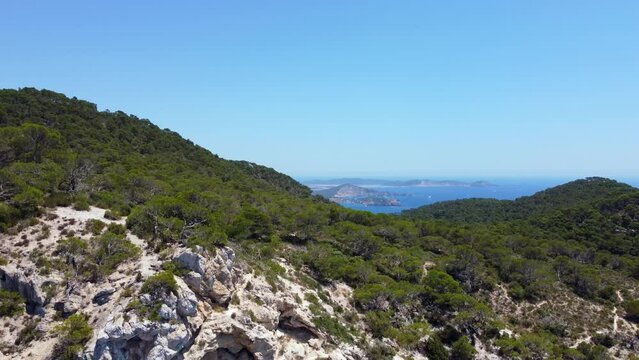Formentera On horizon from highest mountain of Ibiza island
Beautiful aerial view flight pedestal down drone footage of cliff edges hike Es Vedra summer 2022. P. Marnitz 4k Cinematic view from above