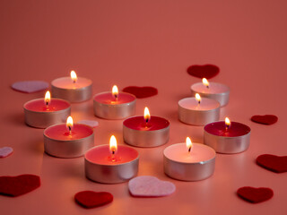 Pink candles on a pink background. Love concept.