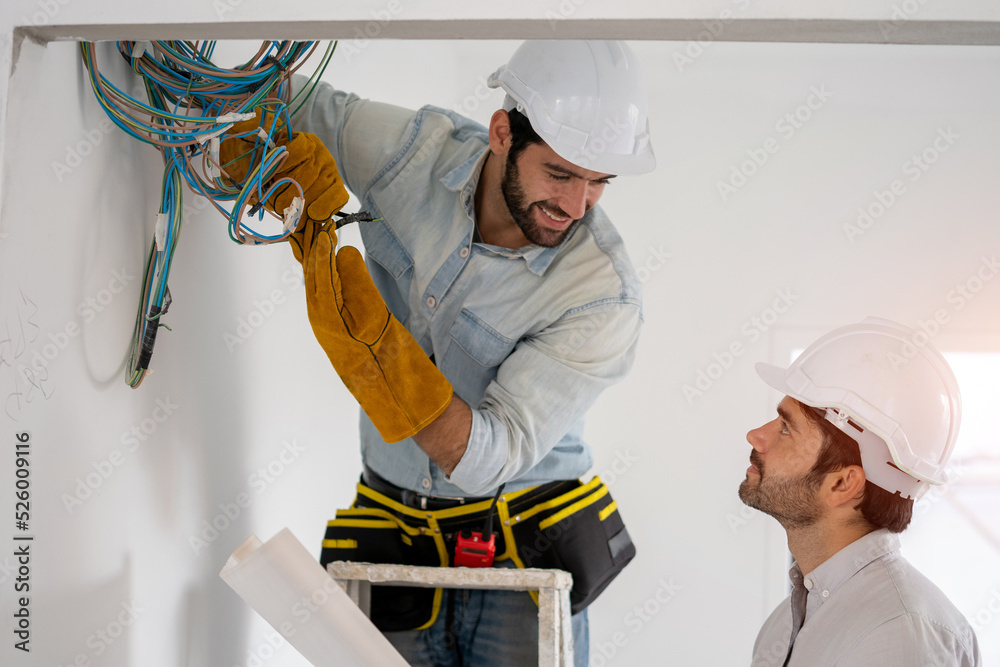 Aufkleber electrician working working on building site, maintenance technicians install wiring in the home.