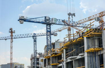 Fototapeta na wymiar Tower crane at the construction site of a multi-storey building.