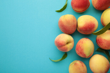 Fresh peaches on a blue background. Space for text
