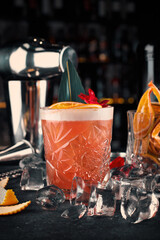 Sour whiskey cocktail on the background of bar accessories