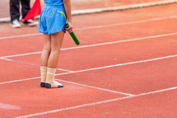 Obraz premium A child athlete runs a race wearing only socks.
