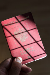 Russian passport in the hands of a man. Prohibition of Schengen visas for Russian tourists to travel to the European Union concept. - obrazy, fototapety, plakaty