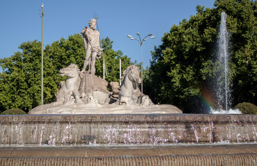 Fountain of Neptune in the old town of Madrid, Spain. The statue shows the god of the sea, with a...