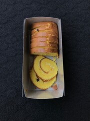 Bolu Gulung (Role Cake) on a dark background