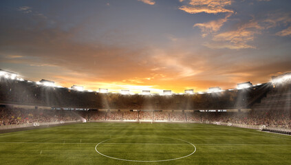 Sunset above empty football field with flashlights and dark night sky background. Stadium with...