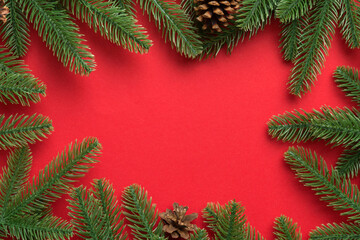 Fototapeta na wymiar Christmas holiday background with copy space for advertising text. Fir branches and pine cone on color background . Flat lay, top view