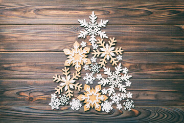 Christmas tree made from colored handmade ball decoration on colored background, view from above. New Year minimal concept with copy space