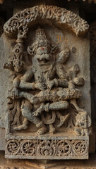 Fototapeta na wymiar The Carving Sculpture of Lord Narshimha Cutting the Stomach of Demon Hiranyakshipu, Lakshminarshimha Temple, Javagal, Hassan, Karnataka, India.