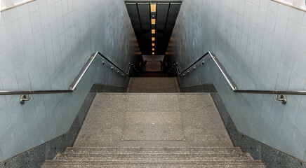 Looking down passageway stairs to subway station