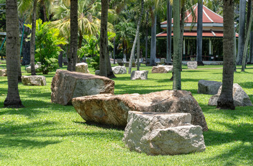 Large rock with grass field in park