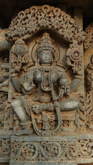 Fototapeta na wymiar The Beautiful Carving Sculpture of Goddess Lakshmi on the Shri Lakshminarshimha Temple, Javagal, Hassa, Karnataka. India. Build by Hoysala Empire.