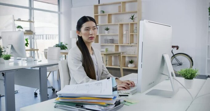 Business, work and documents of a woman getting a pile of files on her desk at the office in the workplace. Female working on computer frustrated and overwhelmed with all the paperwork or paper.