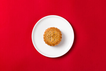 Traditional Chinese mid autumn festival mooncakeon red background.