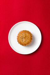Traditional Chinese mid autumn festival mooncakeon red background.