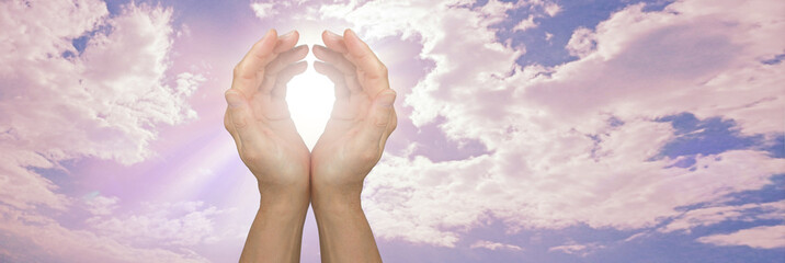 High Frequency remote healing sky message background - cupped hands with white light beside a...