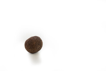 Fragrant, fresh black peppercorns lies on a white background. A single peppercorn on which the details are excellent. Macro shooting, texture details.White background.Top view. isolated object