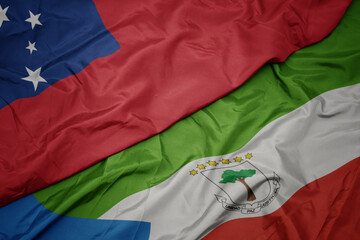 waving colorful flag of equatorial guinea and national flag of Samoa .