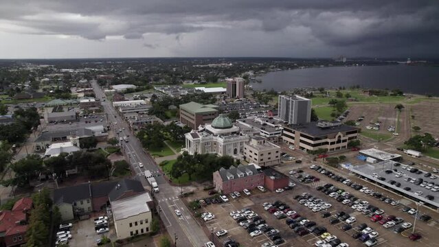 Aerial view of a courthouse in Lake Charles, LA with a storm in the background
