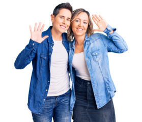 Couple of women wearing casual clothes waiving saying hello happy and smiling, friendly welcome gesture