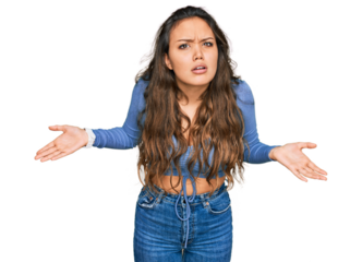 Young hispanic girl wearing casual clothes clueless and confused with open arms, no idea concept.