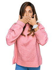 Young hispanic woman wearing casual clothes shocked covering mouth with hands for mistake. secret concept.