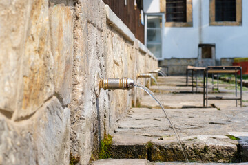 Fountins for prayer in a mosque in gjakova kosova. Golden fountains with water flowing downwards.