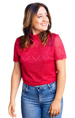 Fototapeta premium Young beautiful caucasian woman wearing casual clothes looking away to side with smile on face, natural expression. laughing confident.