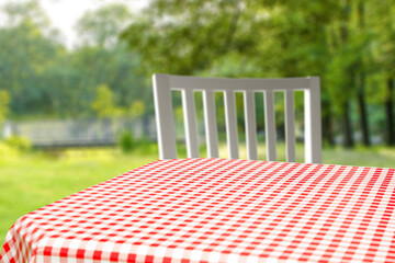 Desk of free space and blurred garden background. 