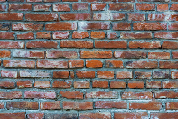 Old red brick wall. Horizontal rows of old bricks. Textured surface. Broken wall.