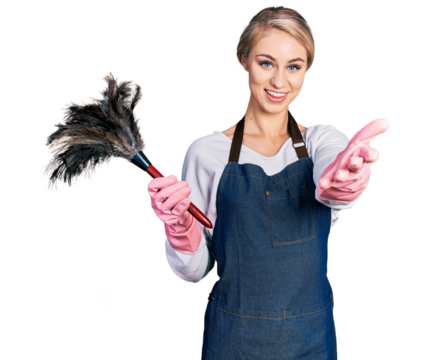 Beautiful young blonde woman wearing apron holding cleaning duster smiling friendly offering handshake as greeting and welcoming. successful business. - Powered by Adobe